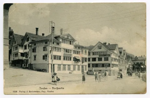 Dorfstrasse. Ecke Gemeindehaus, „Anker“, „Adler“, Blick zur Villa Roth. Posierende Kinder und Frauen mit Kinderwagen, Ochsenfuhrwerk